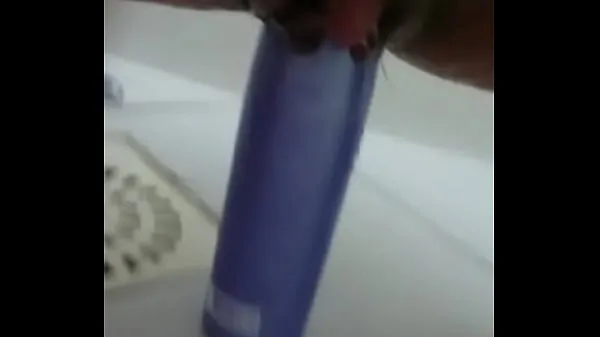 Watch Stuffing the shampoo into the pussy and the growing clitoris warm Videos